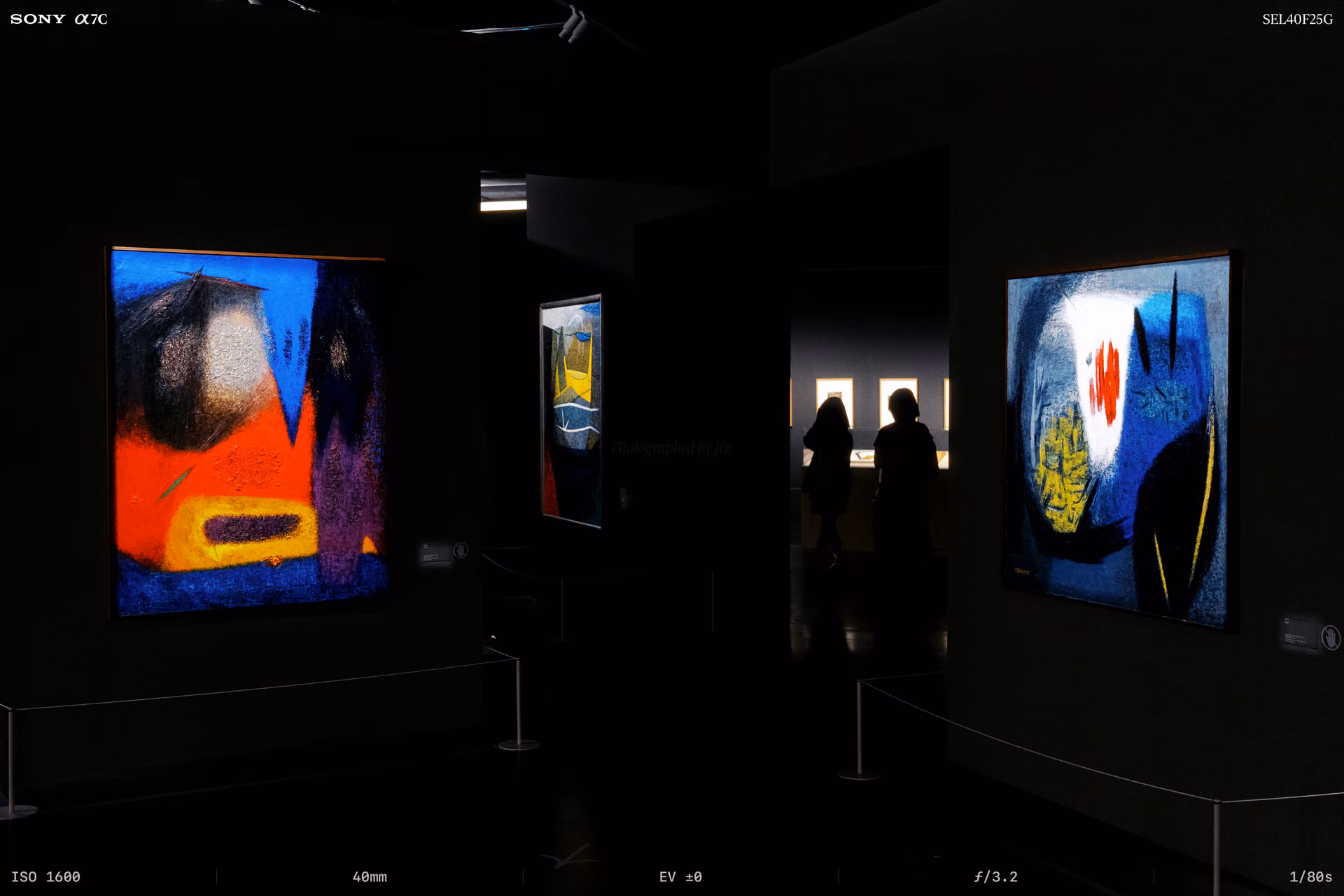 Two paintings in a room with the lights off