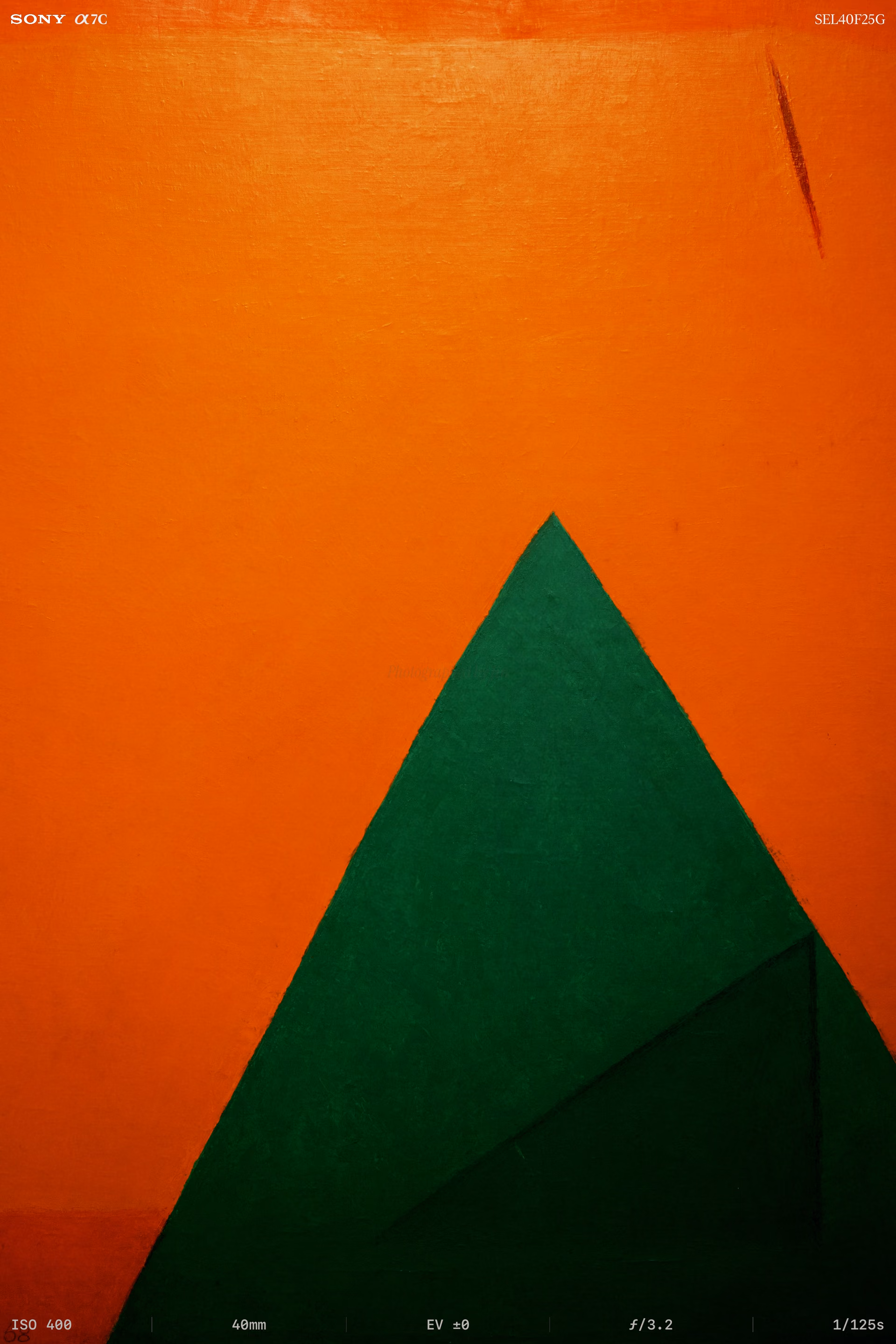 A green triangle standing on orange