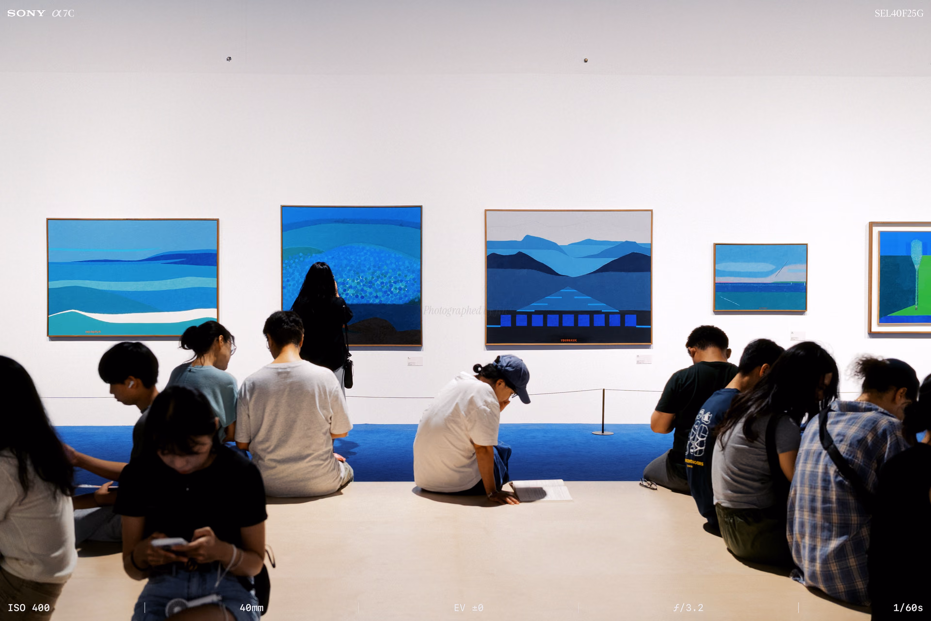 A bench facing the sea paintings