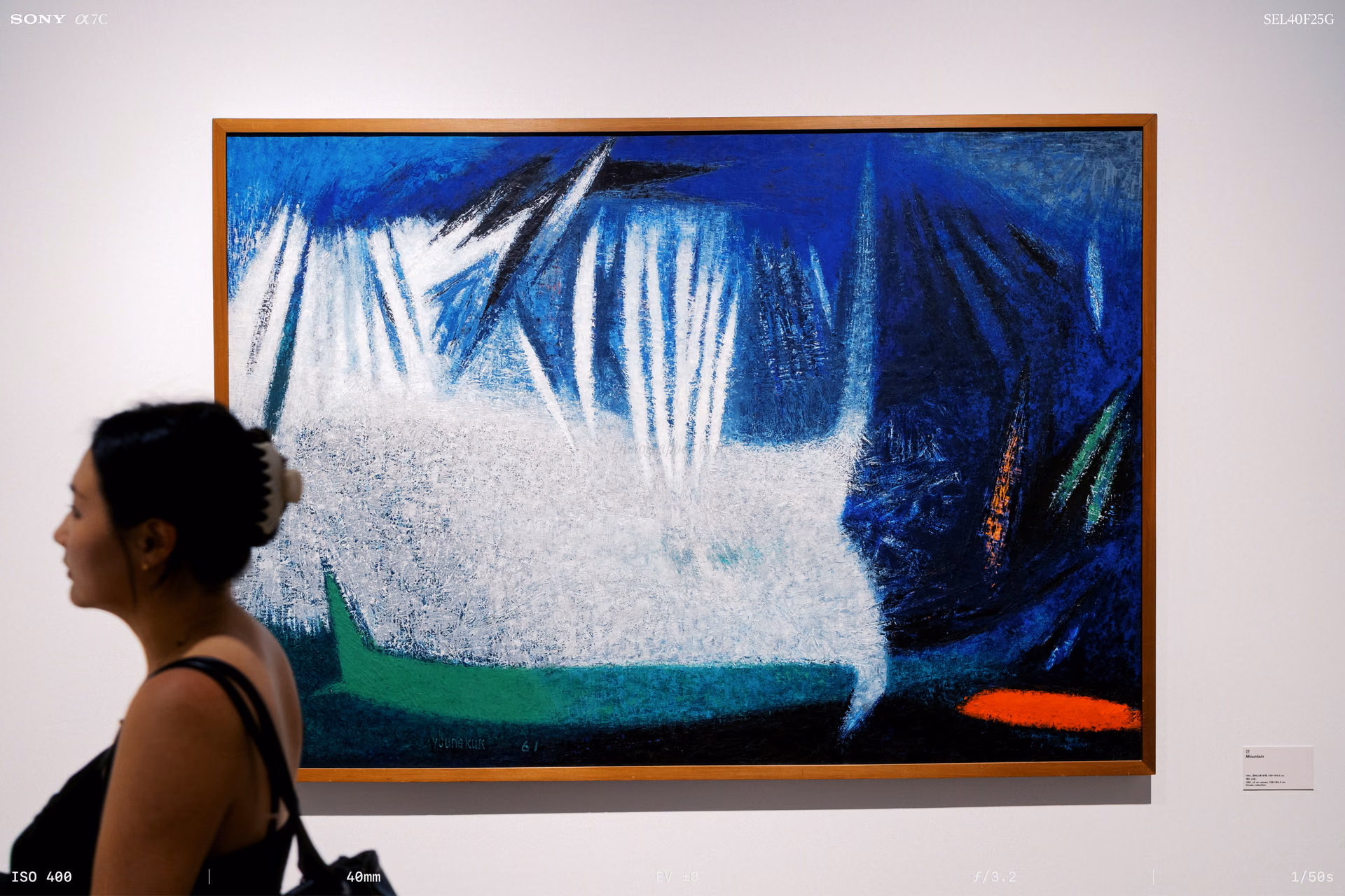 A painting with white strokes rising over blue