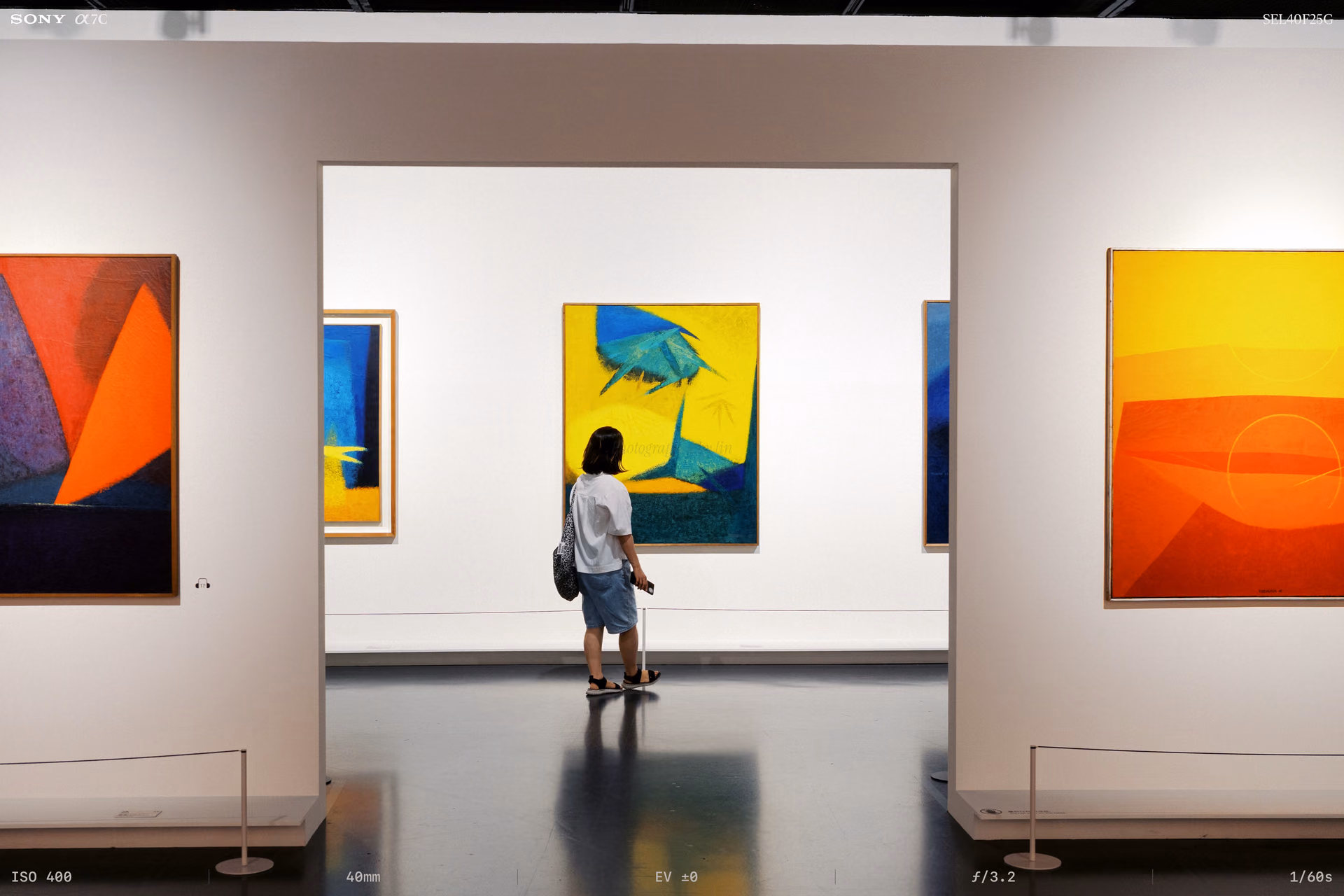 A yellow painting seen through a doorframe
